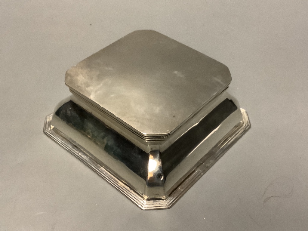 A George V silver mounted cut glass inkwell, goldsmiths and silversmiths Co Ltd, London 1914, 11.4cm and a silver matchbox sleeve.